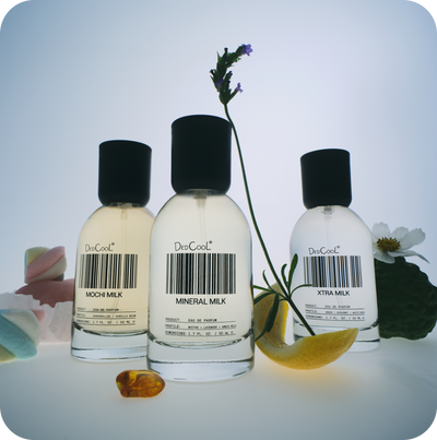 Three perfume bottles labeled 'Mochi Milk', 'Mineral Milk', and 'Xtra Milk' with a bar code on a light background.