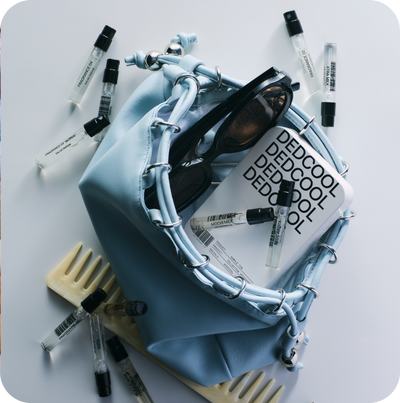 Blue bag with sunglasses and small bottles of Dedcool products