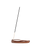 A single incense stick stands upright in a curved, polished brown wooden holder on a plain white background.